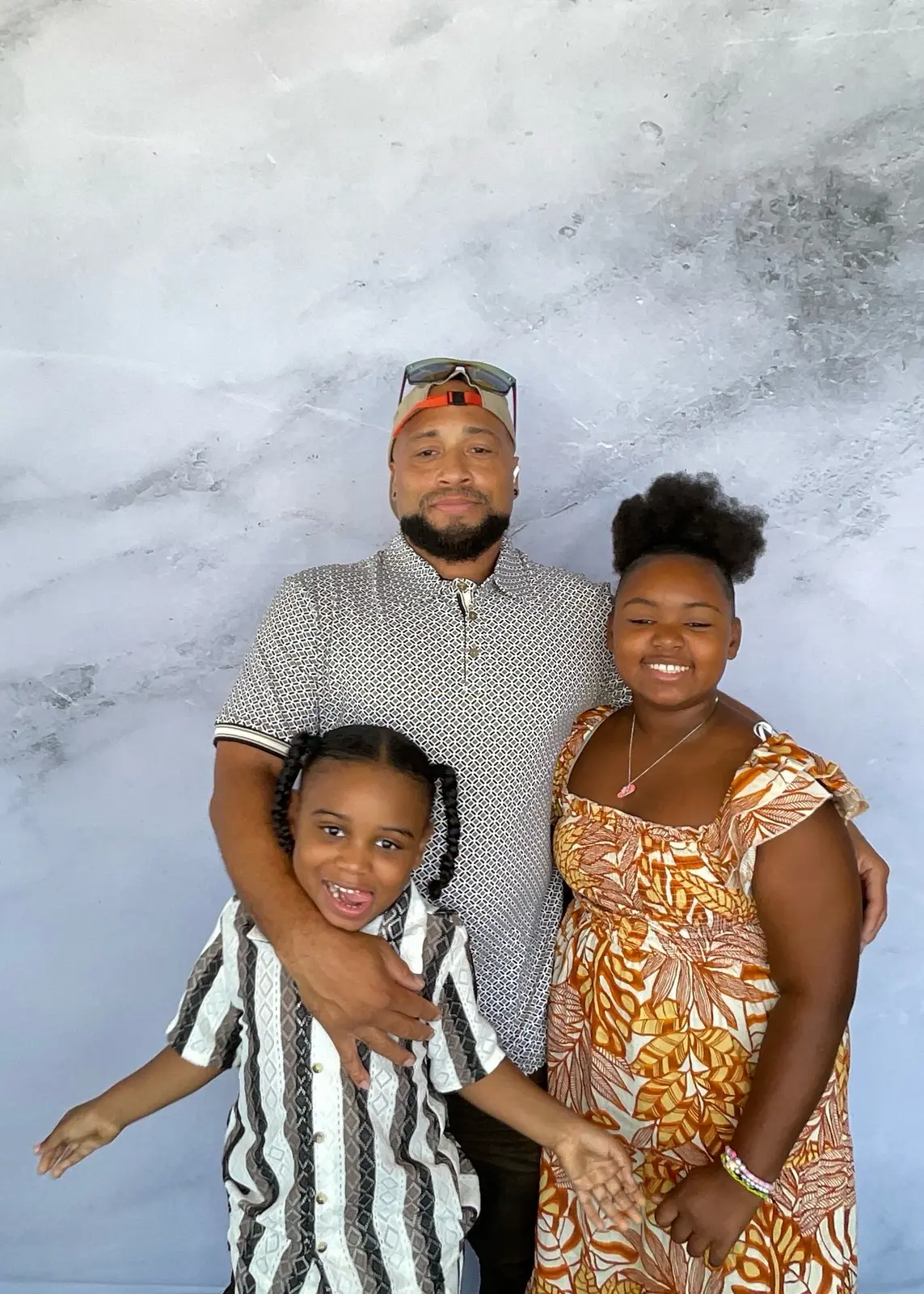 Father and two children enjoying a family photo booth portrait