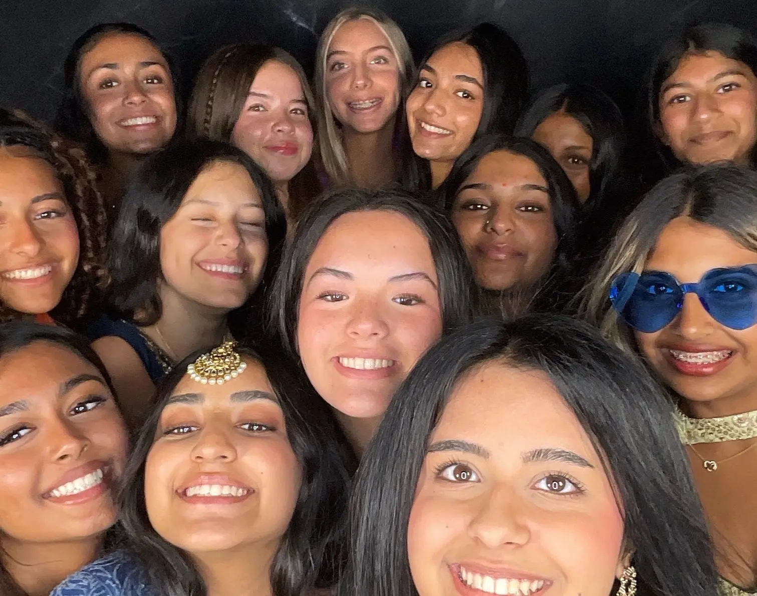 A large group celebrating together in a photo booth