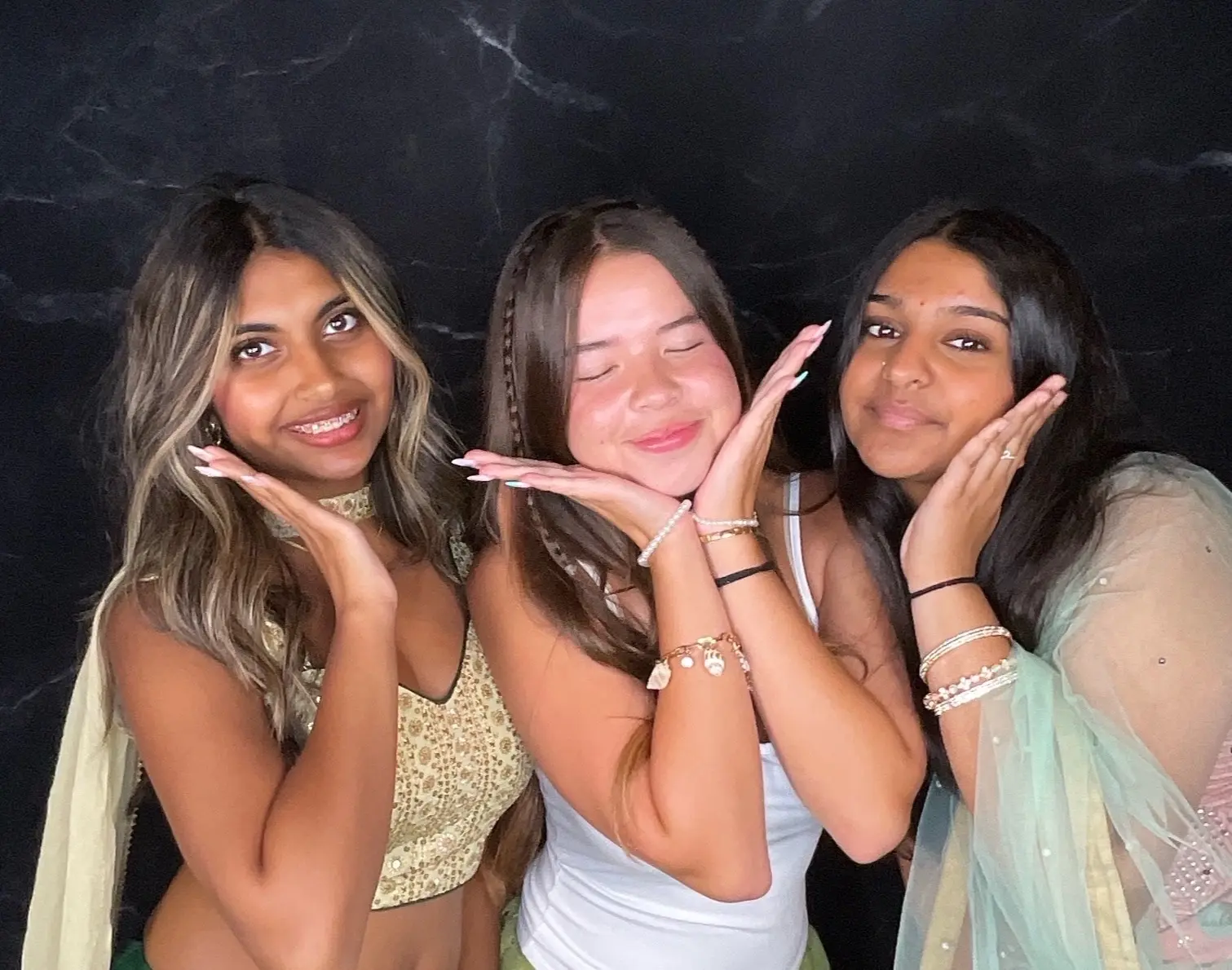 Three friends posing together at a Sweet 16 celebration