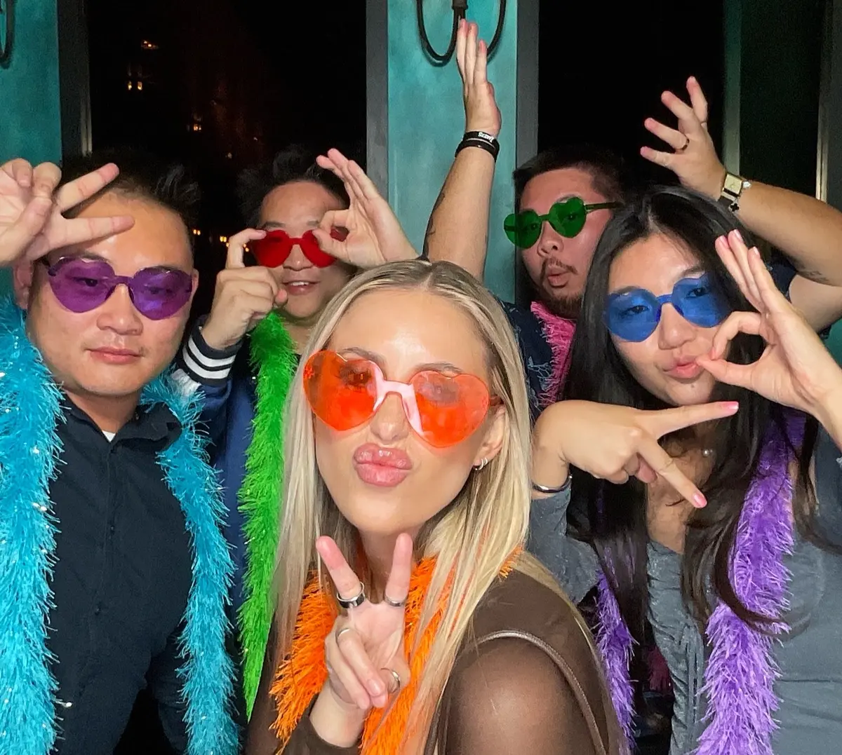 Friends celebrating a 30th birthday with colorful photo booth props, image 2