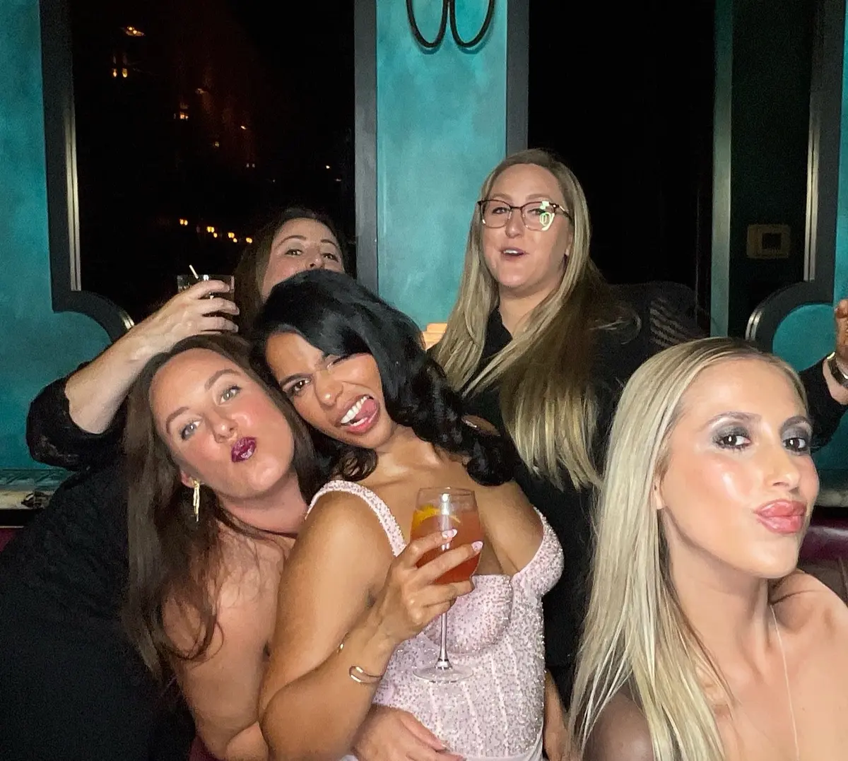 Friends celebrating a 30th birthday with colorful photo booth props, image 8