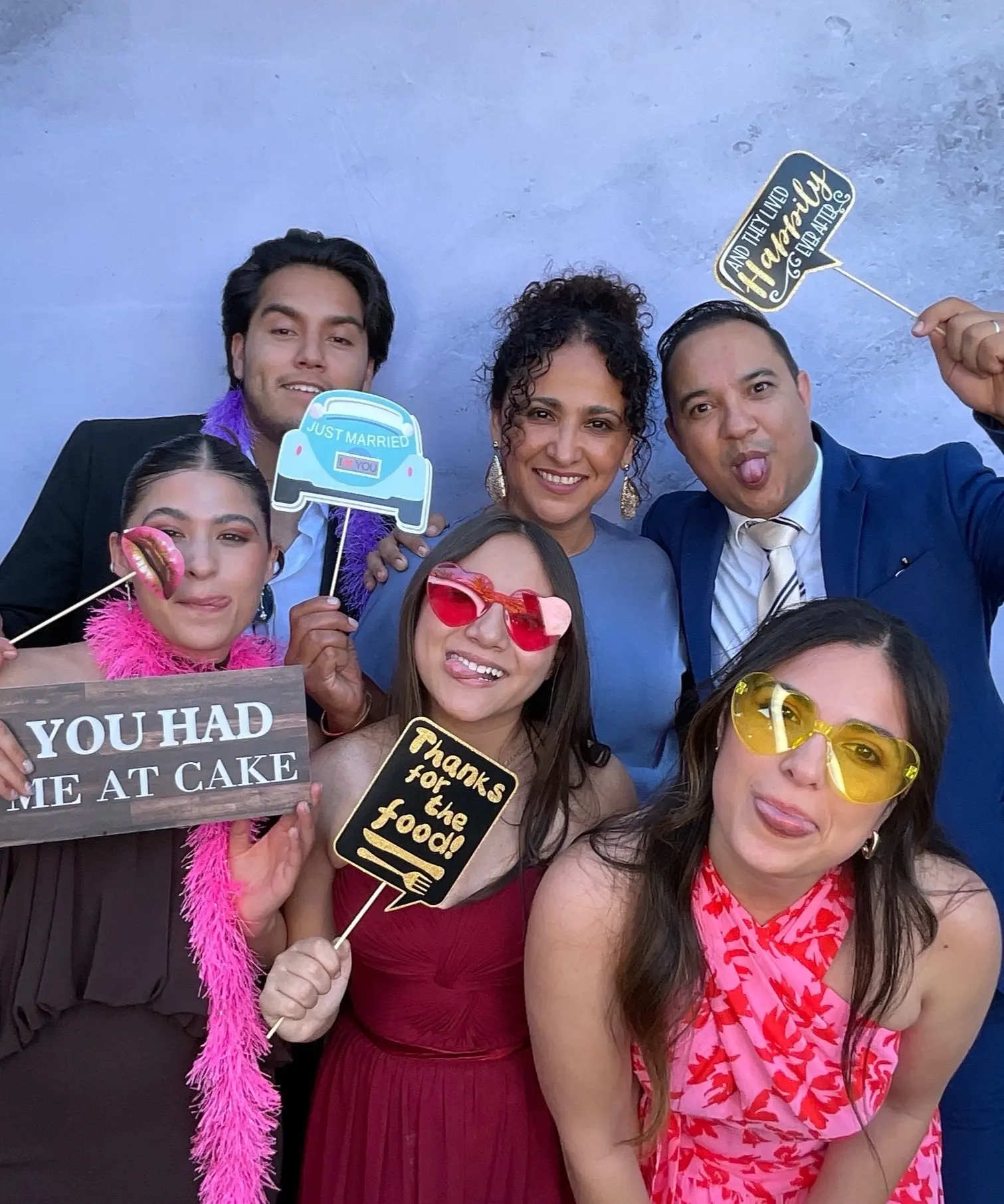 Wedding guests enjoying colorful props in the Halo Halo Memories photo booth