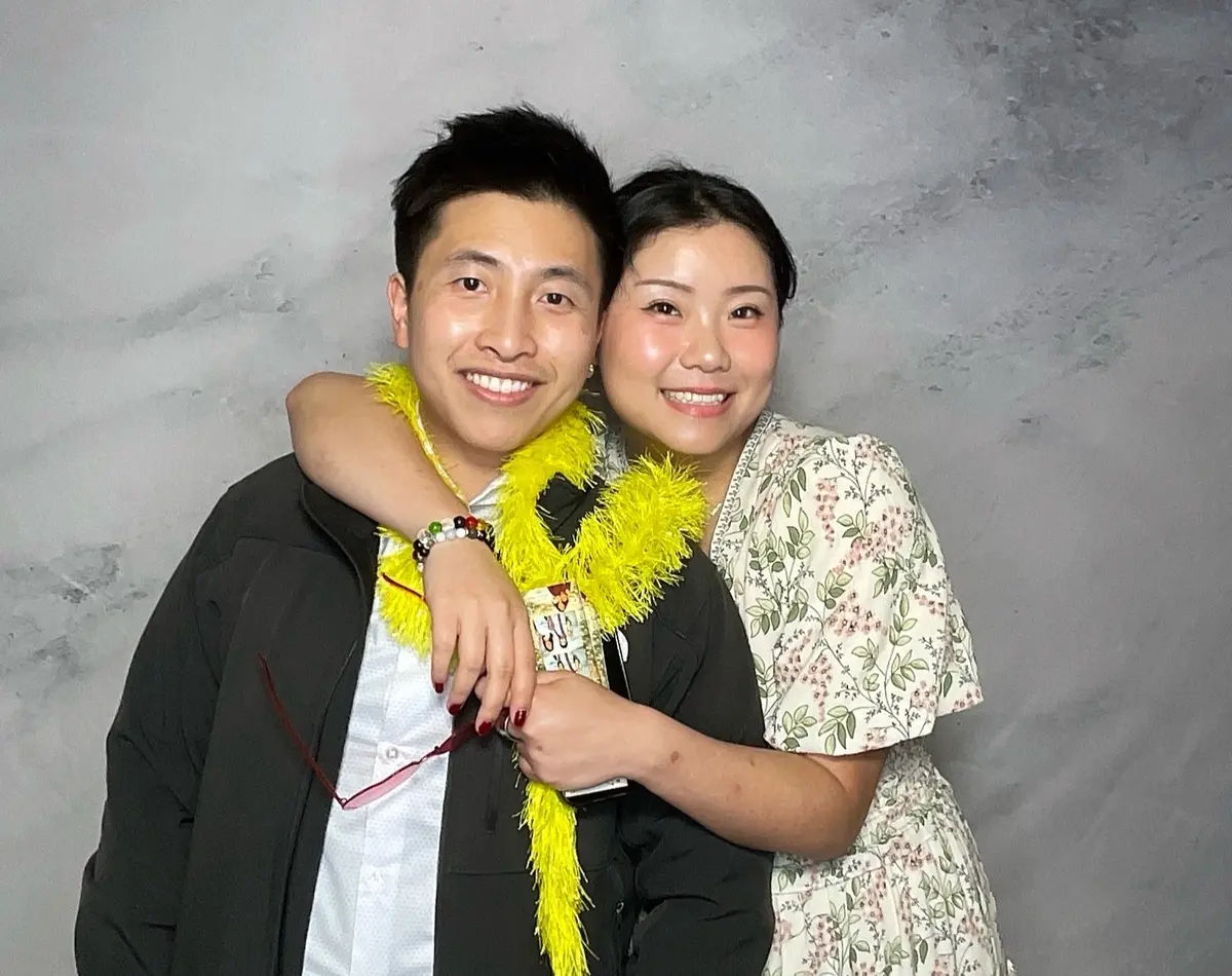 Wedding guests sharing a joyful photo booth moment at a Bay Area reception, image 6