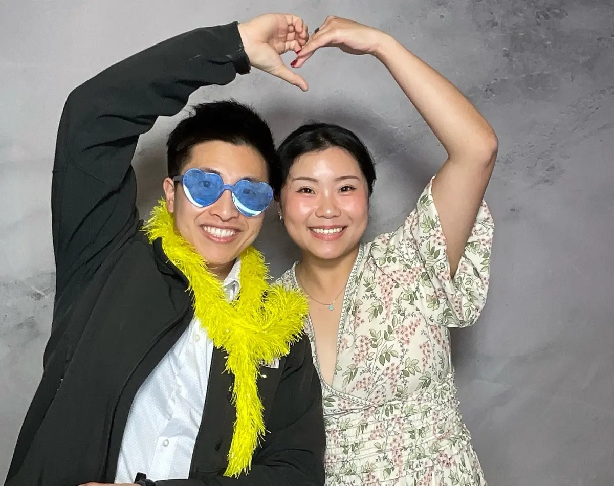 Wedding guests sharing a joyful photo booth moment at a Bay Area reception, image 7