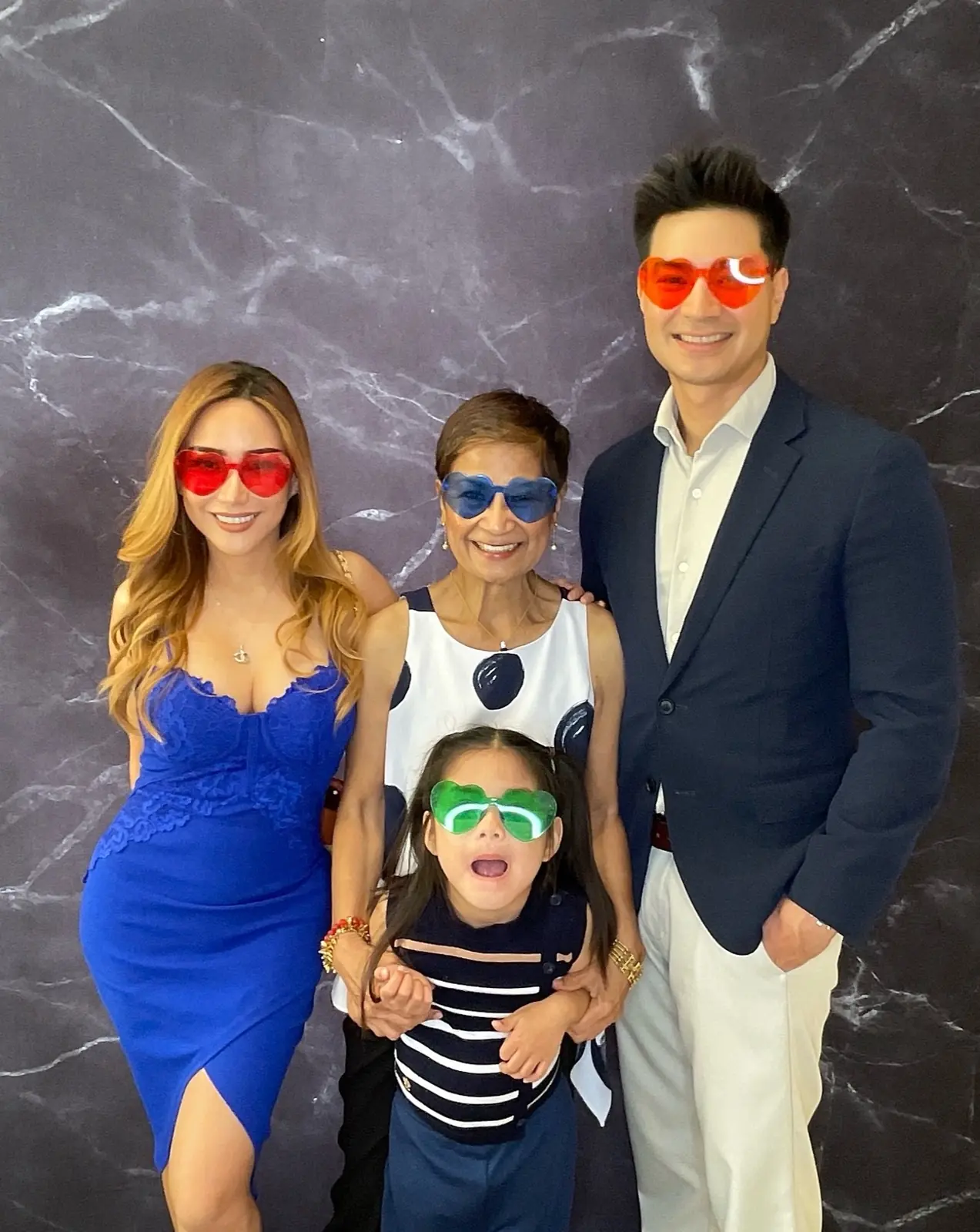 Family group wearing colorful heart-shaped glasses at a San Mateo retirement celebration