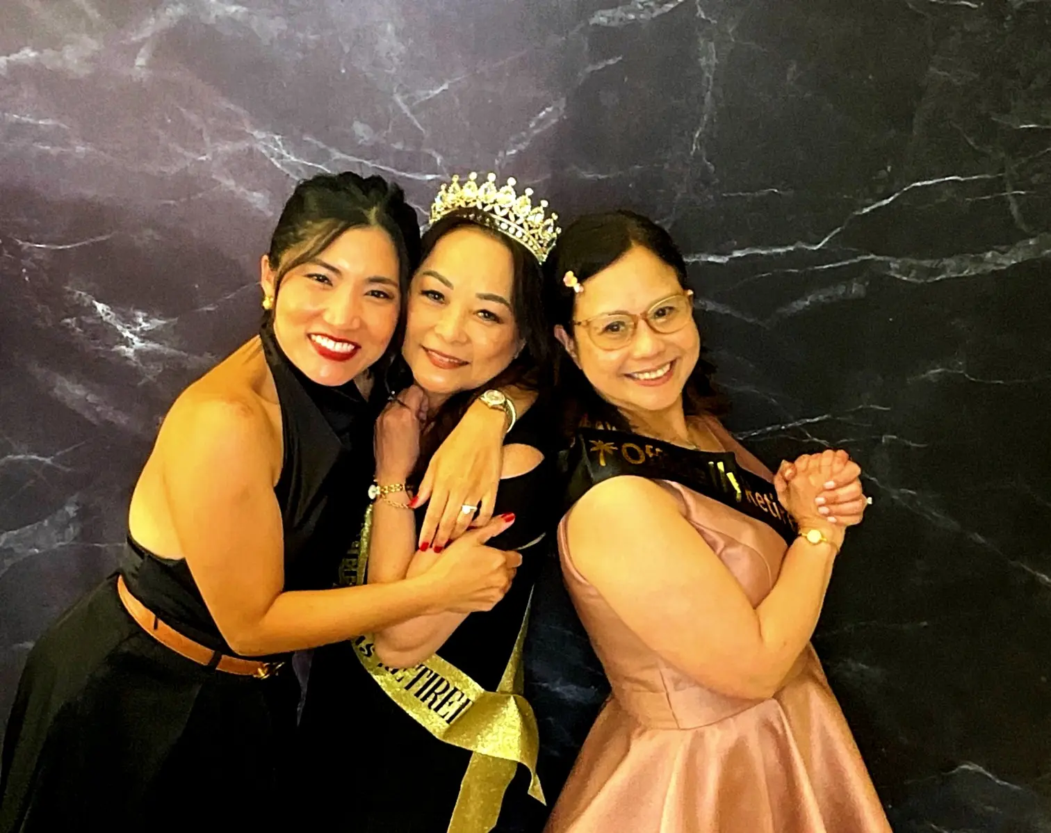 Retirement guest of honor posing with two friends at Hilton Garden Inn