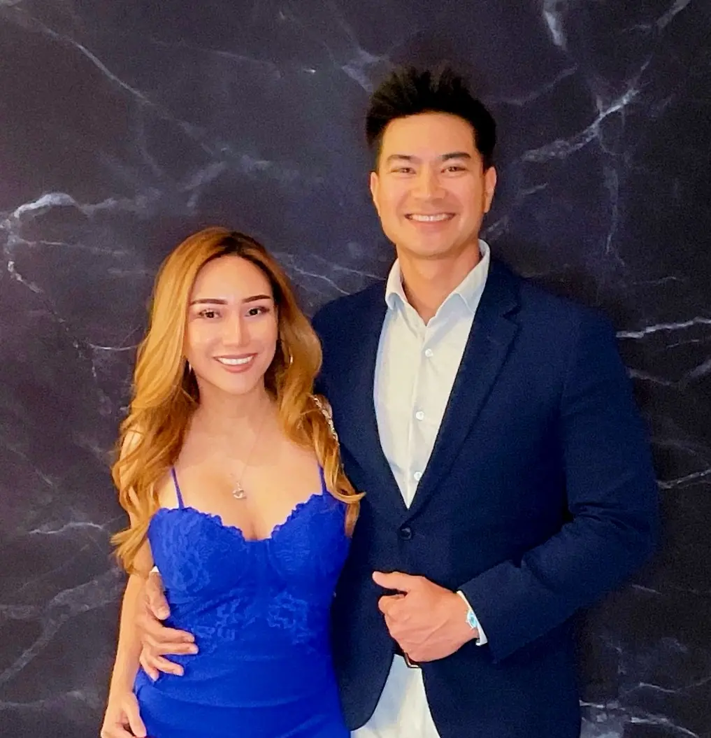 Formally dressed couple posing at the retirement party photo booth