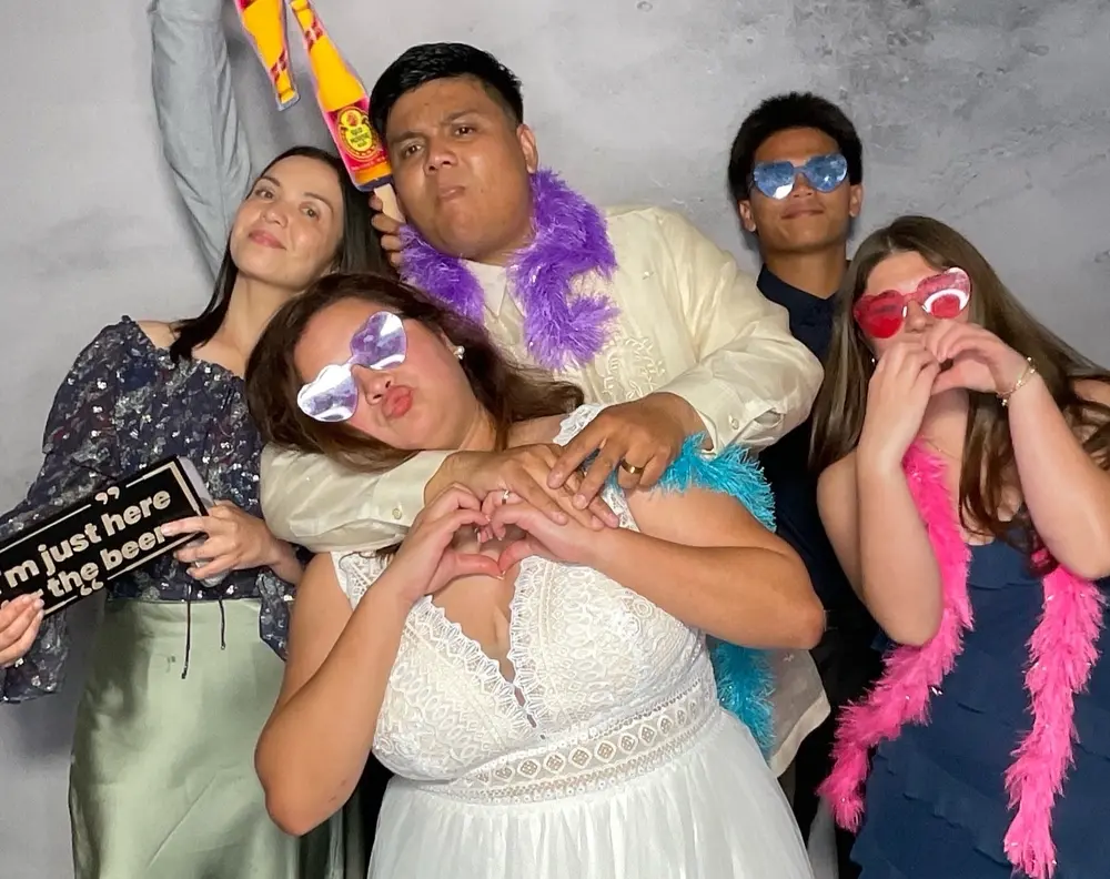Bride and friends striking a funny group pose at the reception