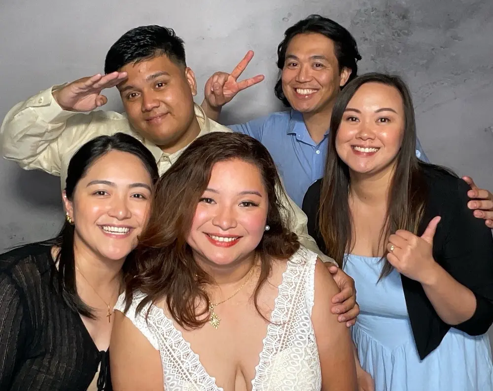 Bride and four friends smiling together at the wedding reception