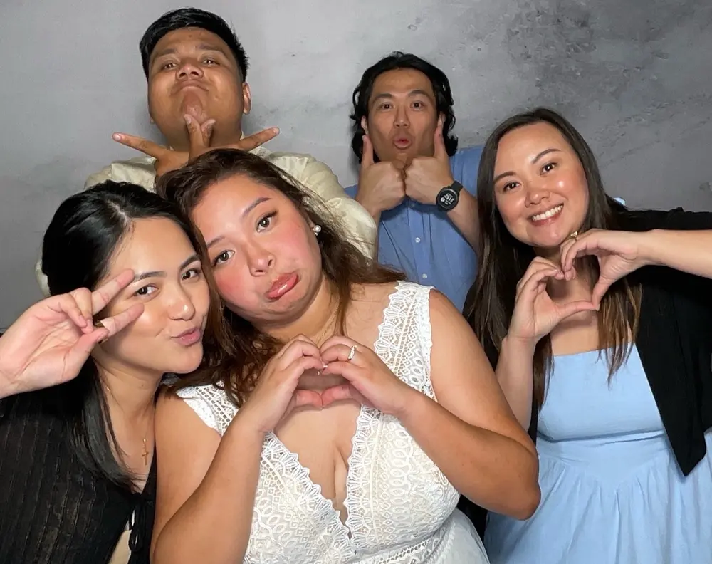 Bride and wedding party making playful faces for the camera