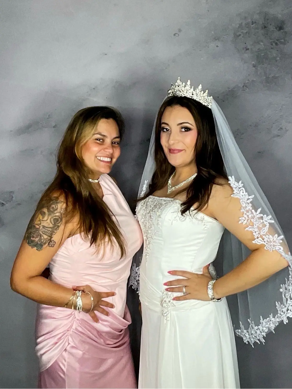 A bride posing with a wedding guest in the photo booth