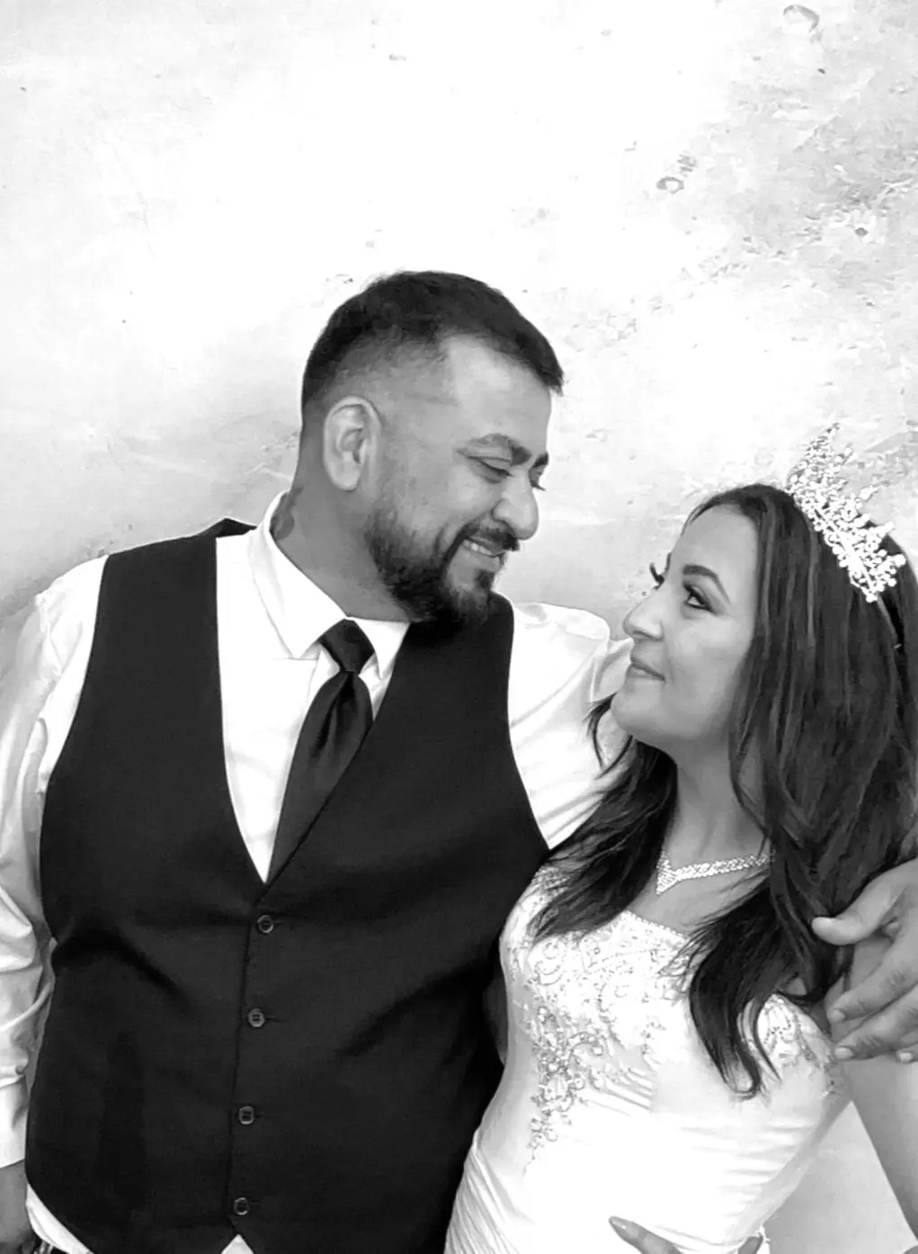 A newlywed couple sharing a quiet moment in the photo booth